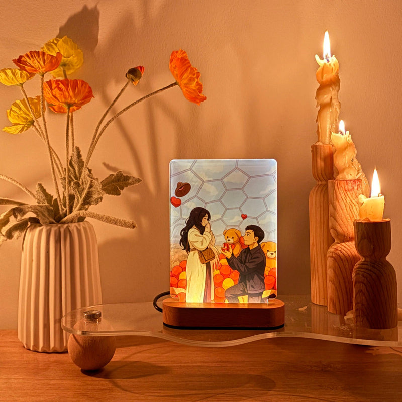 A Decorative scene crafted in a personalized gift lamp, candles, and flowers on a wooden surface.